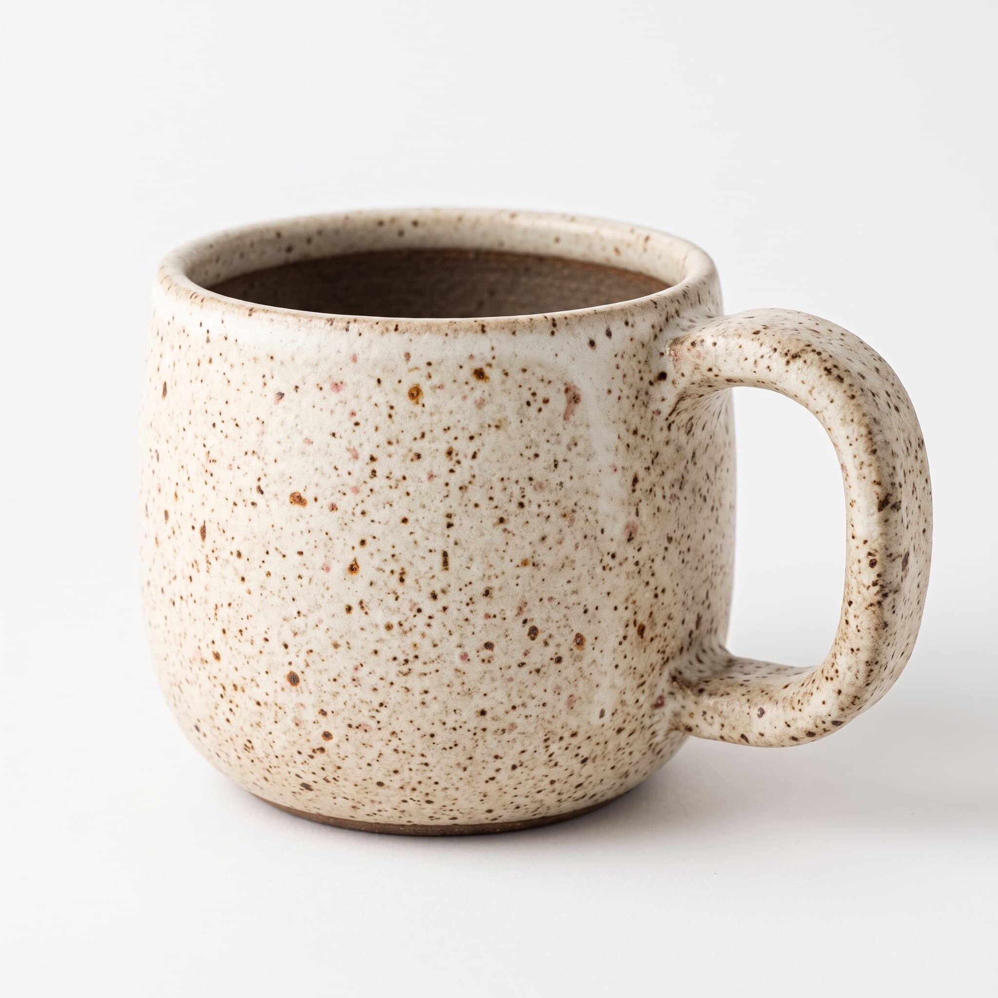 Speckled stoneware mug on a plain white catalog background